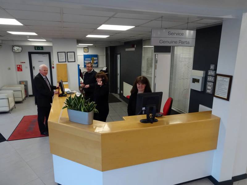 Reception area with staff assisting customers at the service desk